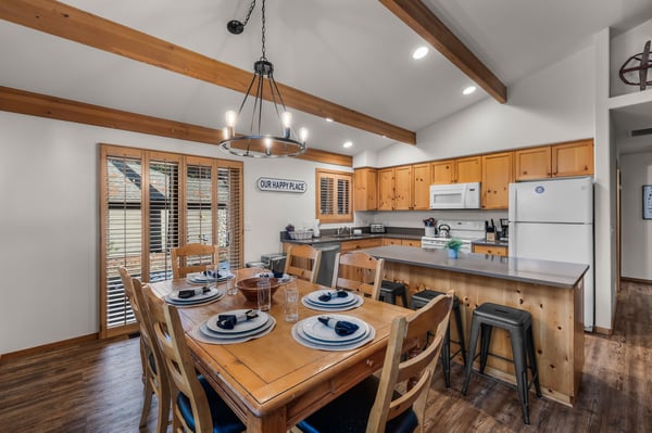 Gather around this warm wood dining table where rustic charm meets modern comfort in your fully-equipped mountain kitchen retreat.