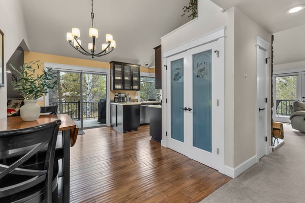 Unwind in your spacious open-concept home where rich hardwood floors flow from dining to kitchen, warmed by elegant lighting and natural views.