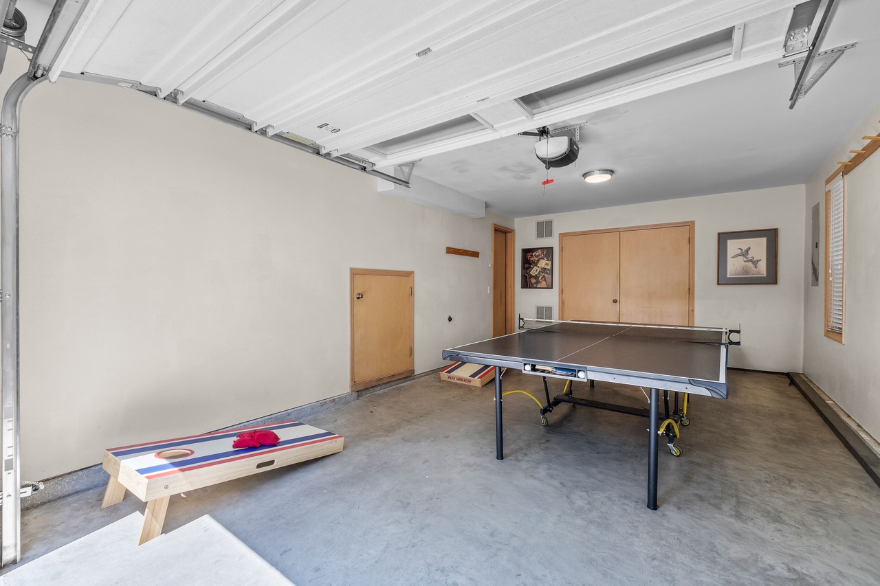 A spacious game area featuring ping pong and cornhole awaits your friendly competition. Enjoy hours of entertainment in this versatile space designed for fun and relaxation.
