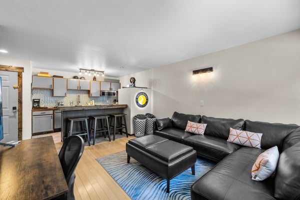 Relax in your stylish open-concept space where the plush leather sectional invites movie nights while the modern kitchen awaits your culinary adventures.