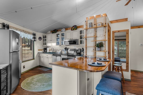 Your fully equipped kitchen awaits with warm wood beams, spacious island, and everything needed to create memorable meals together.