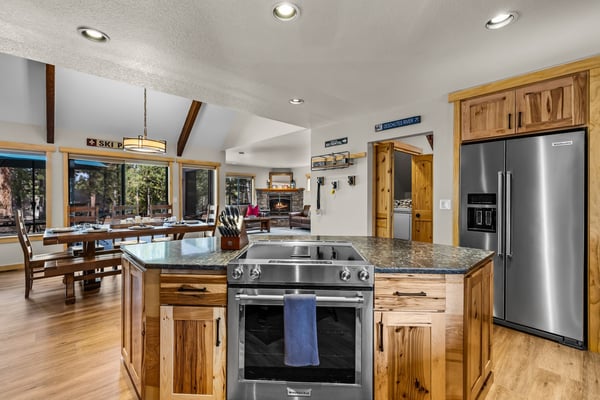 Cook memorable meals in your fully equipped gourmet kitchen with granite counters, stainless appliances, and warm wood finishes throughout.