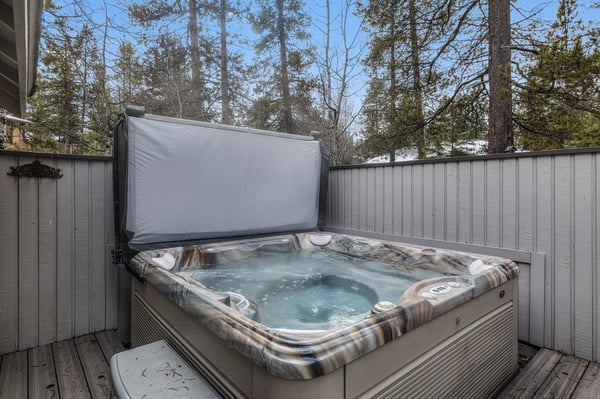 Soak away your stress in this private hot tub, surrounded by tall pines for ultimate relaxation.