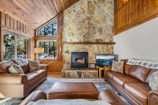 Sink into rich leather sofas by the crackling stone fireplace while gazing at mountain views through soaring windows.