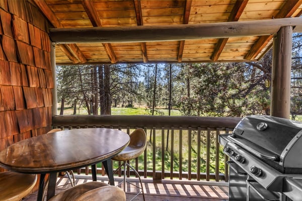 Picture yourself grilling up a fresh meal while soaking in serene forest views from your private covered balcony—the perfect spot for peaceful outdoor dining.