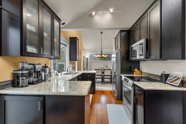 Your gourmet kitchen awaits with granite countertops, stainless appliances, and everything needed to create memorable meals together.
