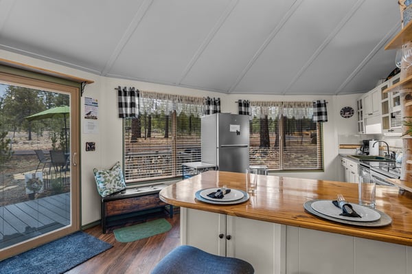 Your cozy kitchen invites morning coffee by sunny windows, with warm wood counters and charming country details creating the perfect breakfast nook.