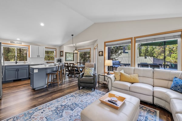 Settle into this open-concept retreat where natural light pours through floor-to-ceiling windows, inviting you to unwind on plush seating or gather around the island for meals and conversation.