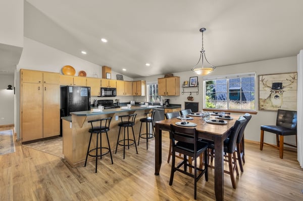 Step into your bright, open kitchen and dining space, where everyone gathers around the inviting island and cozy table. Cook together, share meals, and unwind in this warm, sunlit heart of the home.