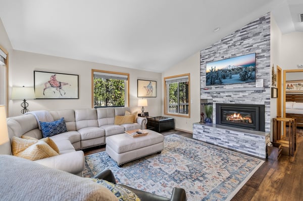 Sink into plush sectional seating surrounded by warm wood tones and the gentle glow of your private fireplace—your perfect retreat after a day exploring the mountains.